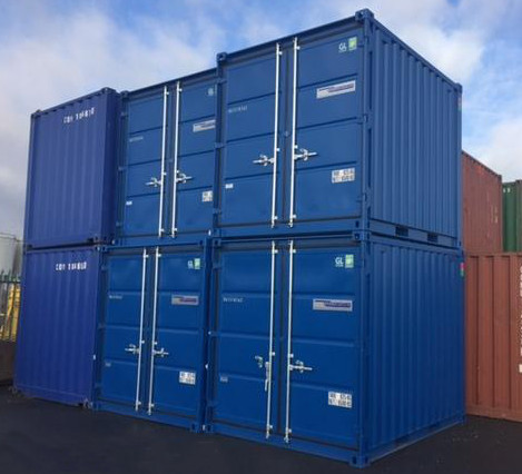 Blue shipping containers stacked two high with closed cargo doors