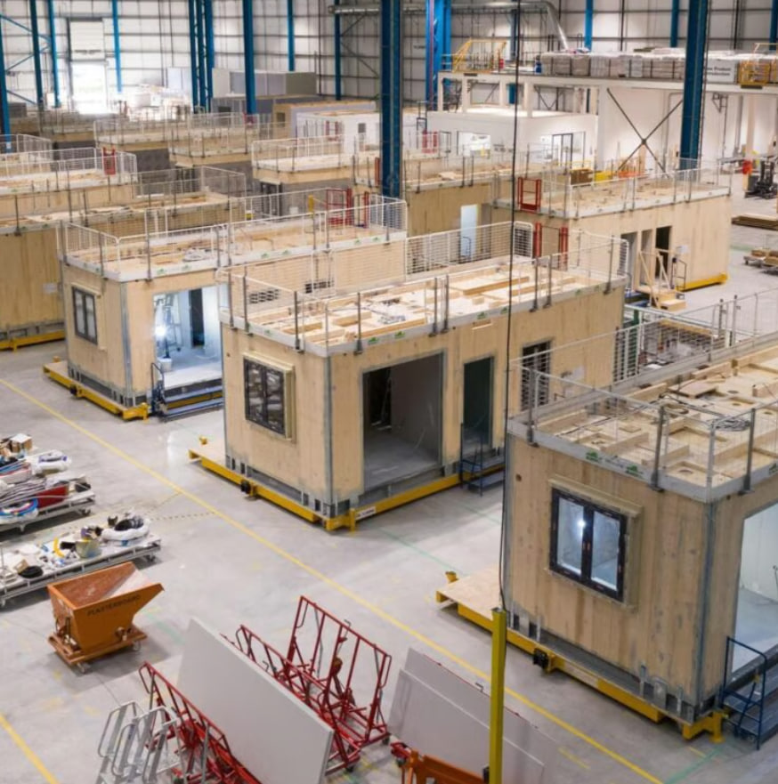 Prefabricated building modules being assembled inside a factory
